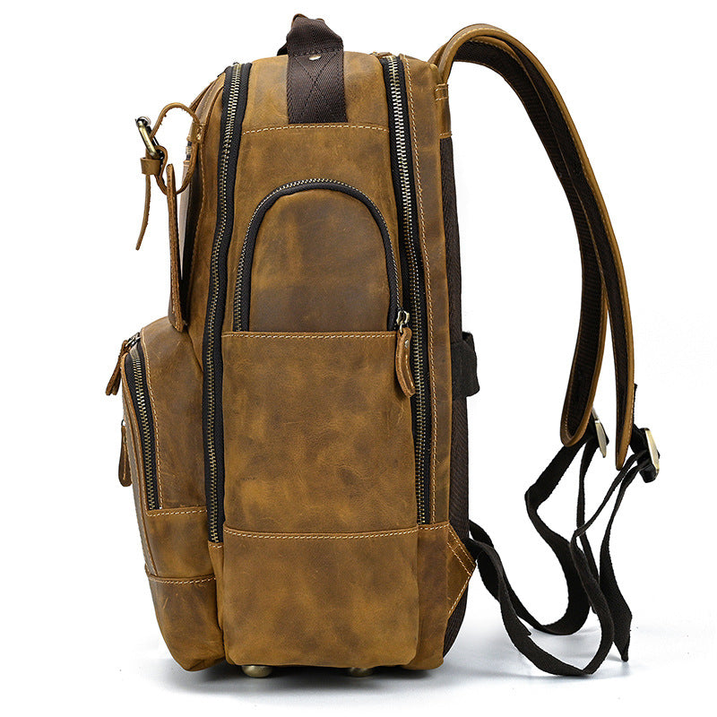 Light Brown leather backpack with multiple zippers on a white background