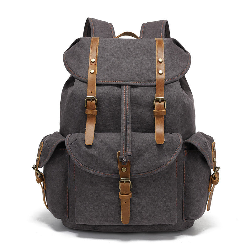 Front view of the Timbercarry vintage canvas multi-pocket backpack in dark grey, showcasing a versatile neutral color with functional leather strap closures.