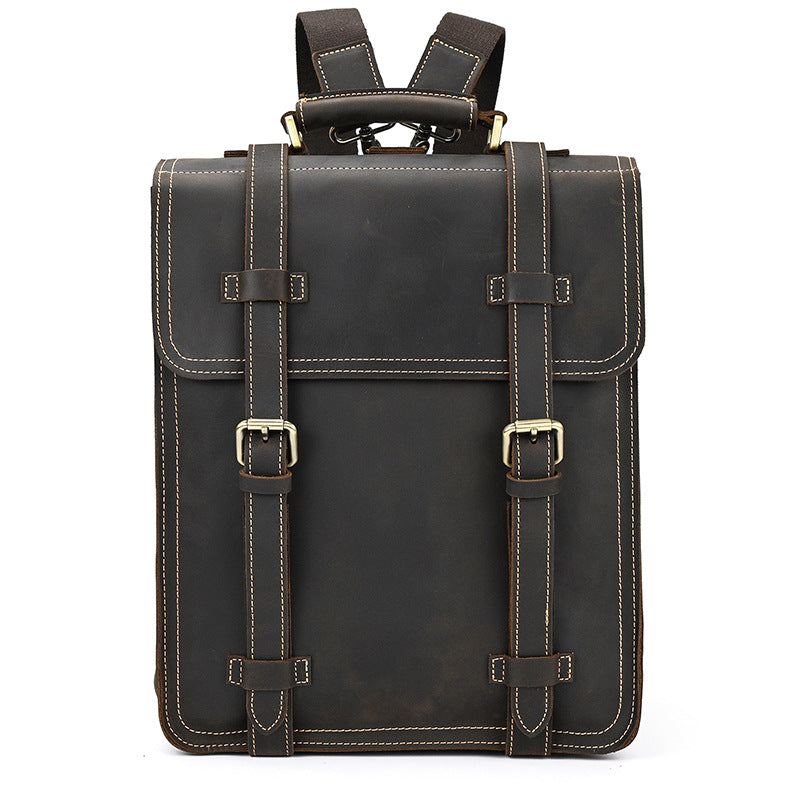 Dark Brown leather backpack with gold buckles on a white background