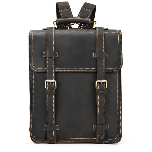 Dark Brown leather backpack with gold buckles on a white background