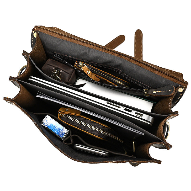Dark Brown leather briefcase with compartments and items inside on a white background