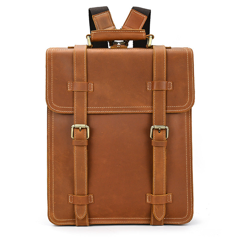 Brown leather backpack with gold buckles on a white background