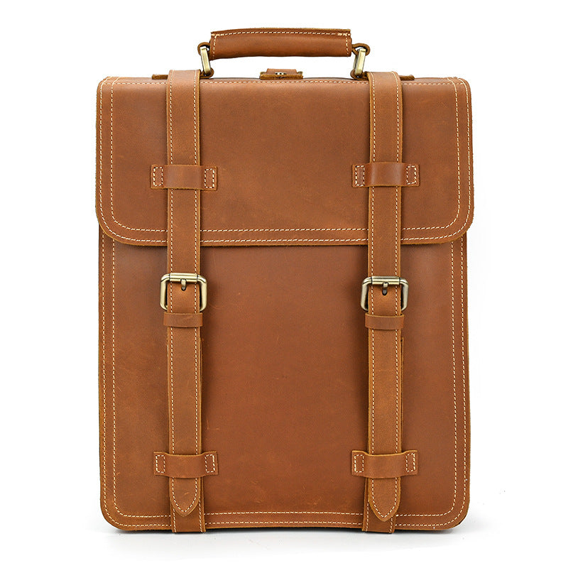 Brown leather briefcase with gold buckles on a white background