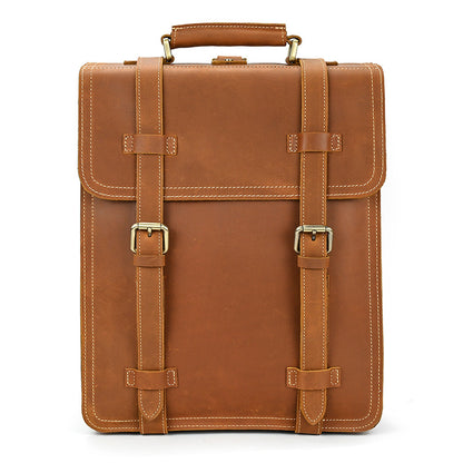Brown leather briefcase with gold buckles on a white background