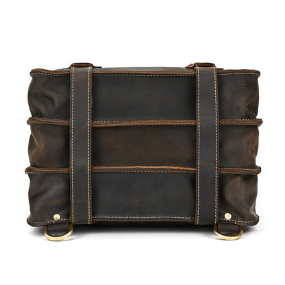bottom view of Dark Brown leather bag with straps on a white background