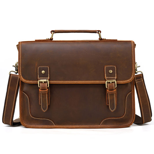 Front view of a Brown Crazy Horse Leather Briefcase with two decorative buckle straps and an executive minimal design.