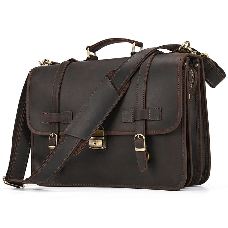 Vintage Crazy Horse leather briefcase with adjustable shoulder strap and brass hardware front view.