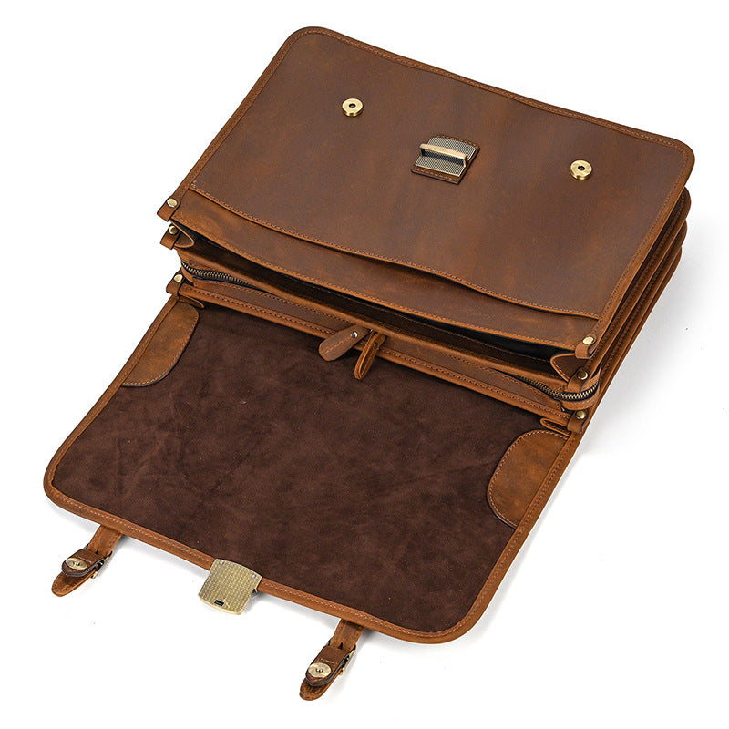 Open flap of light brown leather briefcase showing magnetic snaps and interior suede lining.