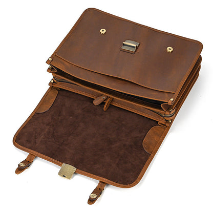 Open flap of light brown leather briefcase showing magnetic snaps and interior suede lining.