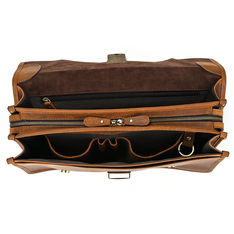 Interior view of multi-compartment leather business bag with pen slots and laptop divider.