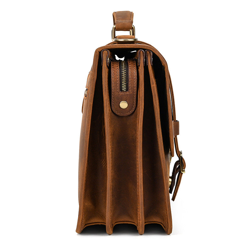 Side profile of triple-compartment light brown leather bag showing spacious gussets.