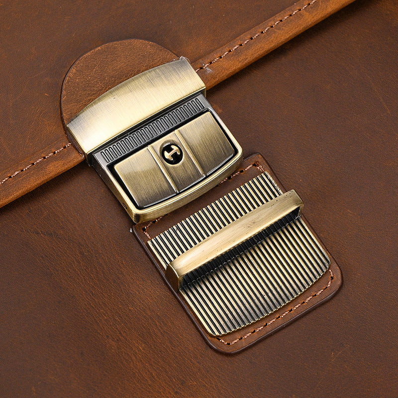 Close-up of a leather belt with a brass buckle on a brown leather background