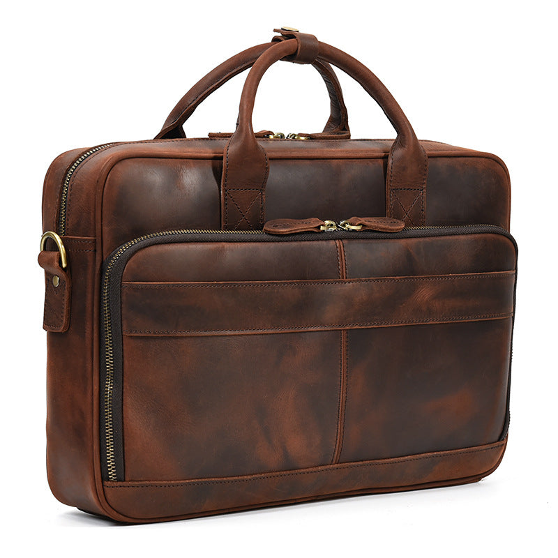 Side-angled view of the Brown leather laptop bag showing the spacious front zipper compartment and rich grain.