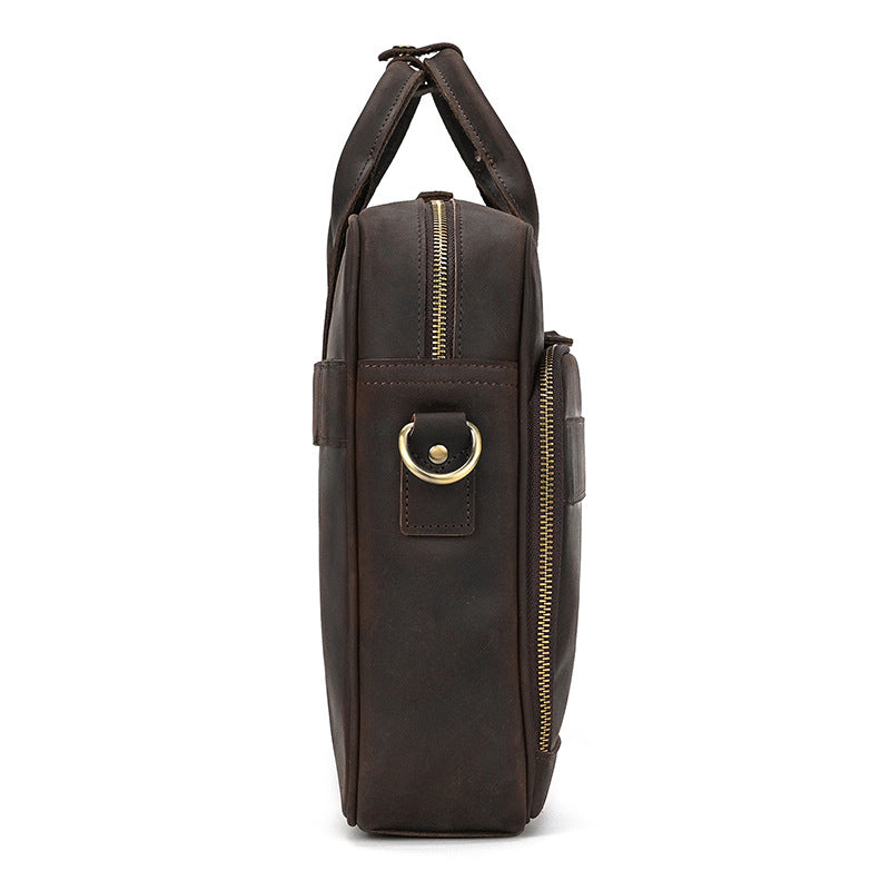 side view of a Dark Brown vintage leather messenger bag with an adjustable and detachable strap.