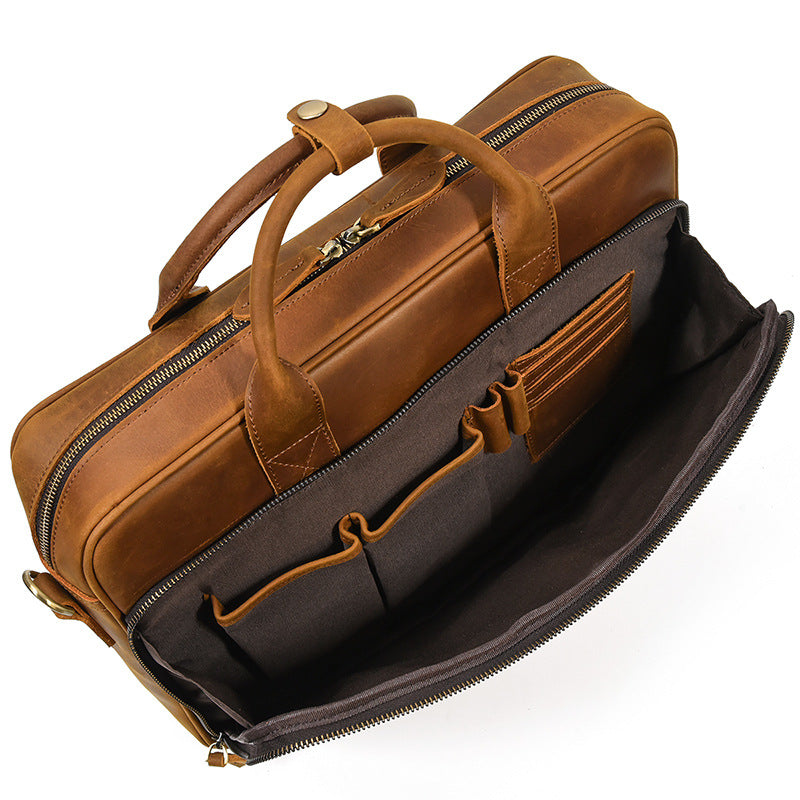 Interior detail of the leather business bag featuring multiple pockets for pens, cards, and a smartphone.