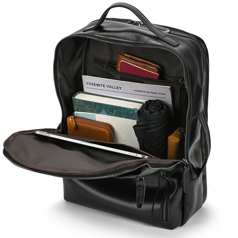 Classic Black backpack with items like a passport and notebook inside on a white background