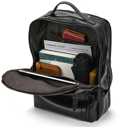 Classic Black backpack with items like a passport and notebook inside on a white background