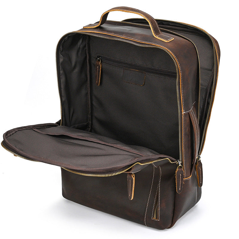 Vintage Brown leather backpack with open front compartment on a white background