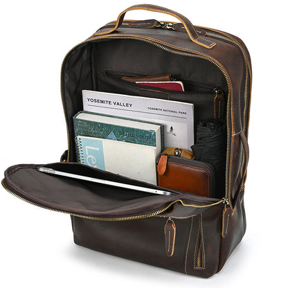 Vintage Brown leather backpack with interior compartments and items on a white background