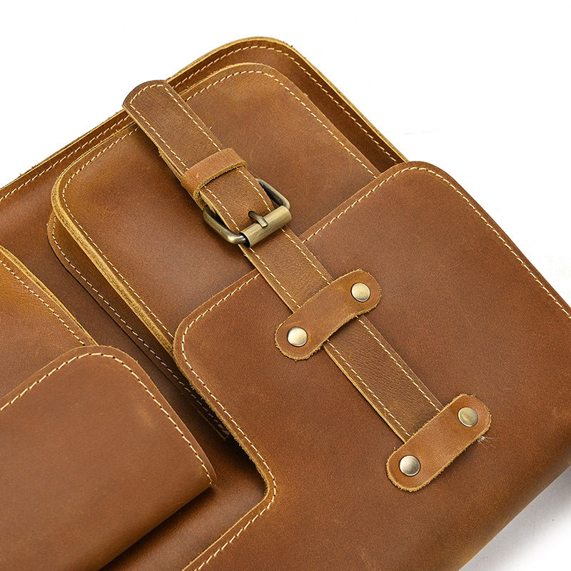 Brown leather bag with gold buckle on a white background