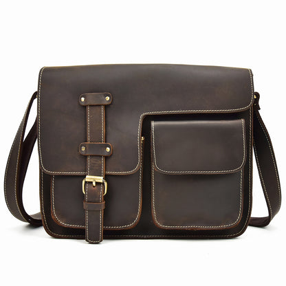 Brown leather satchel bag with a strap on a white background