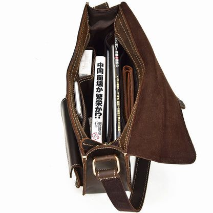 Brown leather bag with a strap on a white background