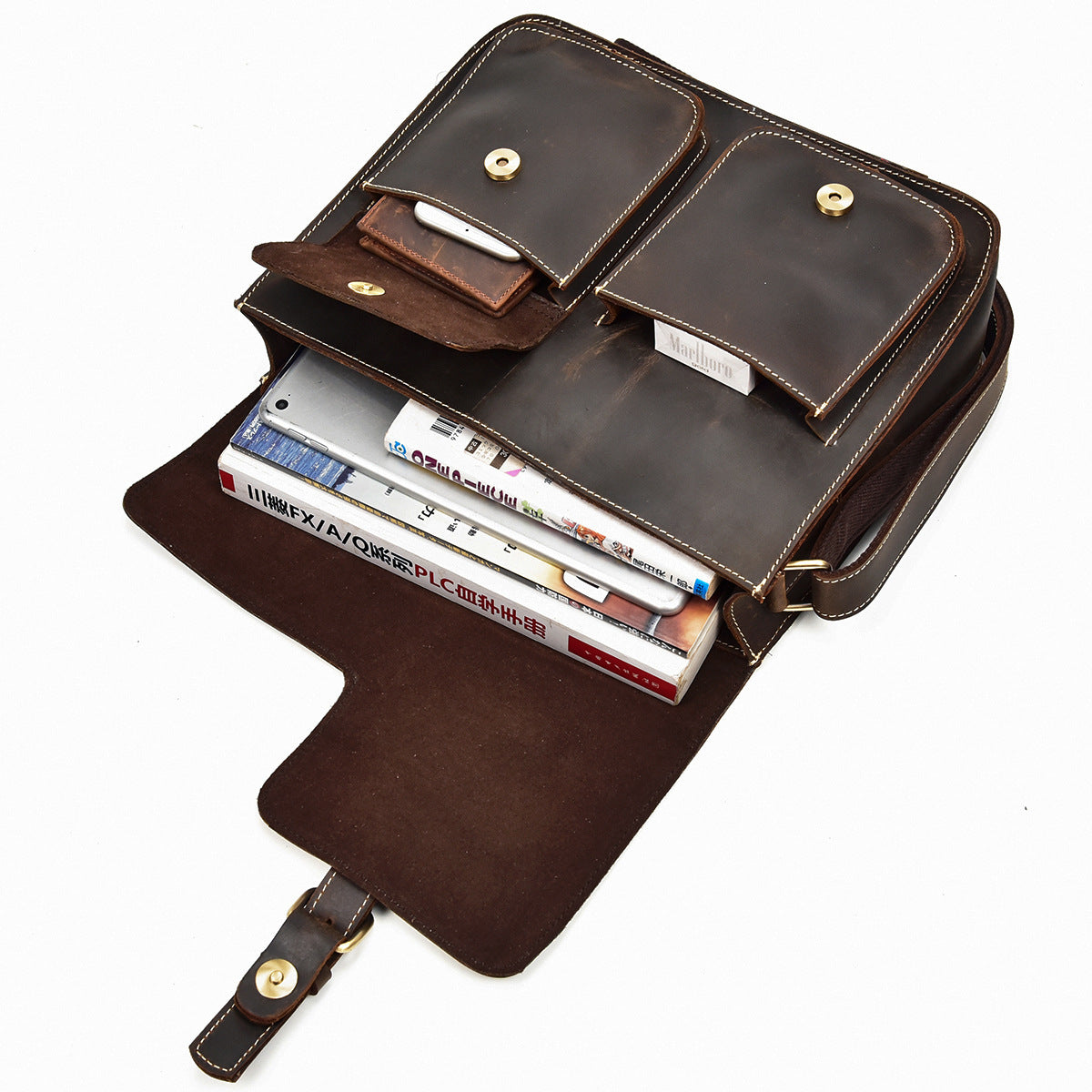 Brown leather briefcase with books inside on a white background