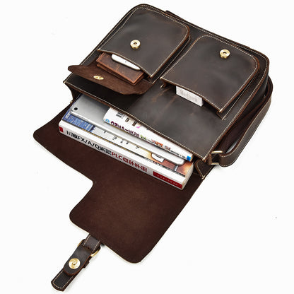 Brown leather briefcase with books inside on a white background