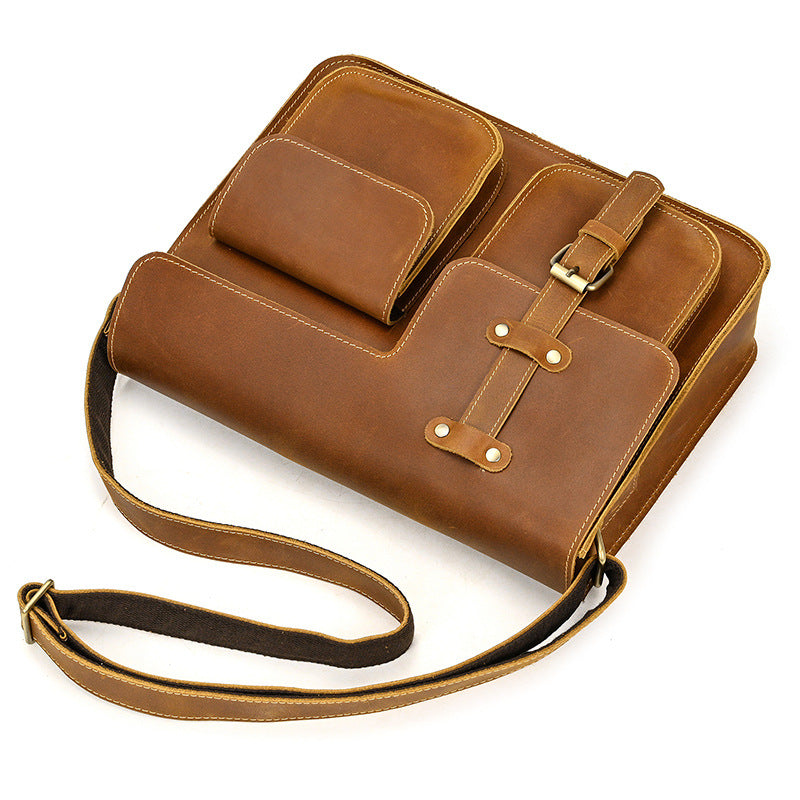 Brown leather bag with a strap on a white background