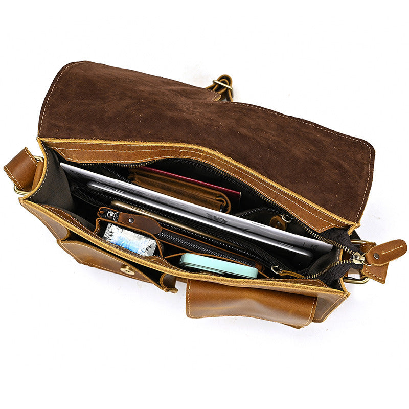 Brown leather bag with compartments on a white background