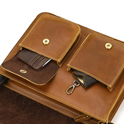 Brown leather bag with multiple pockets and a strap on a white background