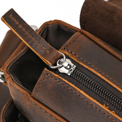Close-up of a brown leather bag with a zipper
