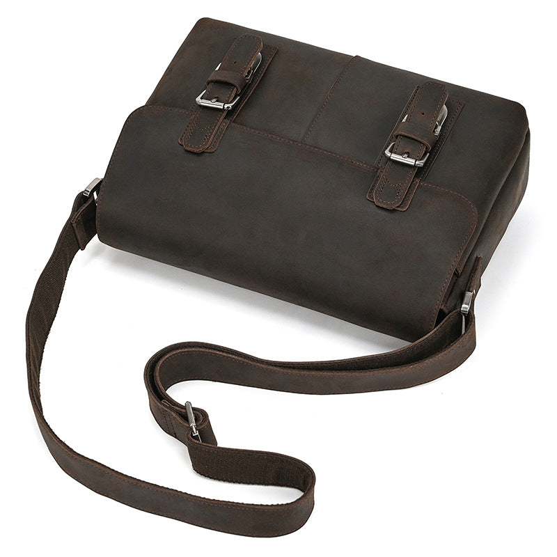 Brown leather bag with straps on a white background