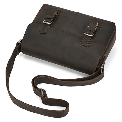 Brown leather bag with straps on a white background