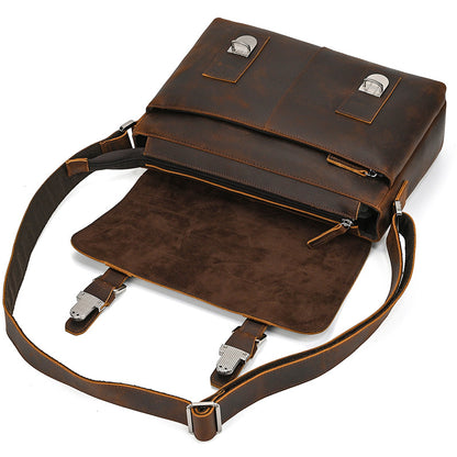 Brown leather bag with a shoulder strap on a white background