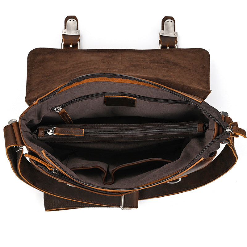 Brown leather bag with open front showing interior on a white background