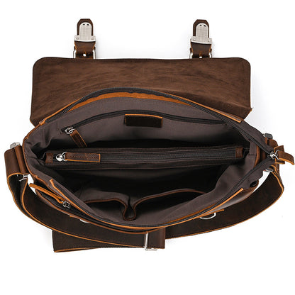 Brown leather bag with open front showing interior on a white background