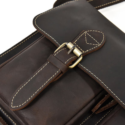 Close-up of a brown leather bag with a buckle on a white background