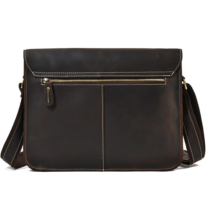 Brown leather shoulder bag with a visible zipper on a white background