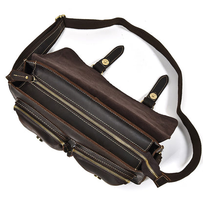Brown leather bag with multiple zippers on a white background
