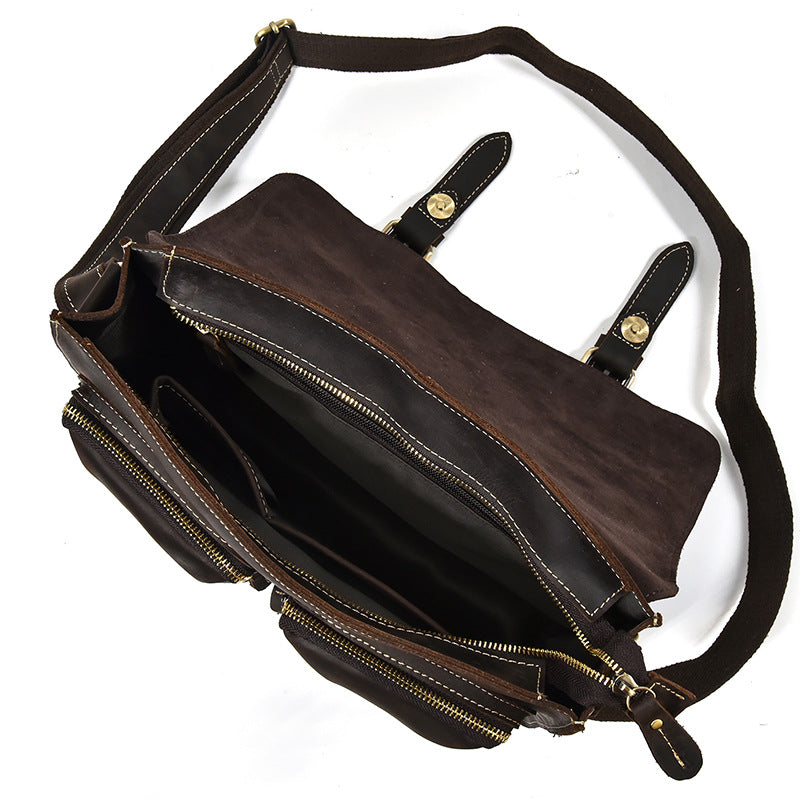 Brown leather bag with gold zippers on a white background