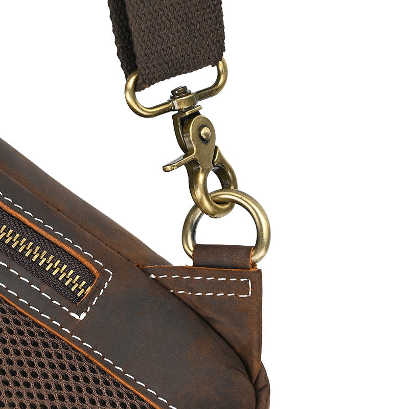 Close-up of a brown leather bag with a gold clasp on a white background