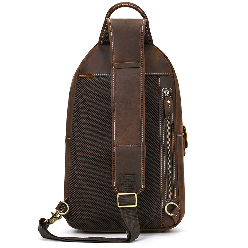 Brown leather backpack with a shoulder strap on a white background