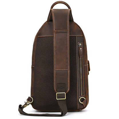 Brown leather backpack with a shoulder strap on a white background