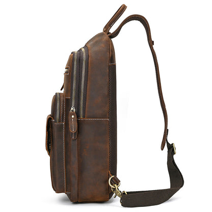 Brown leather backpack with multiple pockets and a shoulder strap on a white background