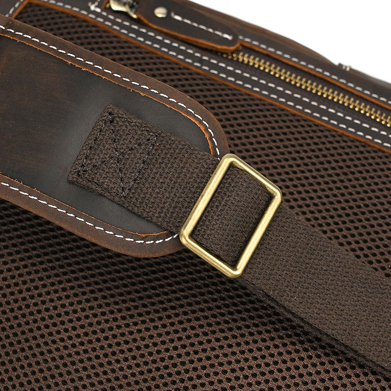 Close-up of a brown bag with a gold buckle on a white background