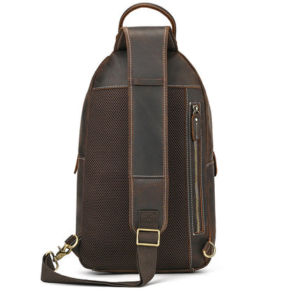 Brown leather backpack with a shoulder strap on a white background