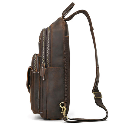 Brown leather backpack with multiple zippers on a white background