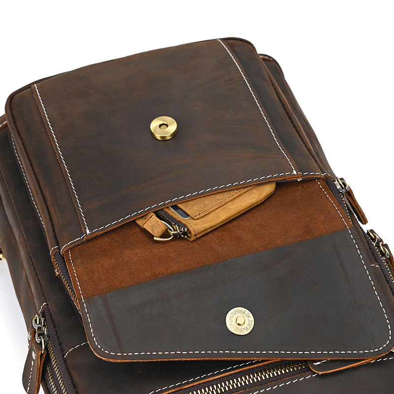 Brown leather bag with gold hardware on a white background