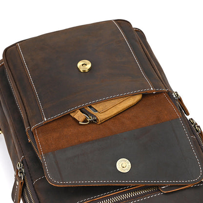 Brown leather bag with gold hardware on a white background